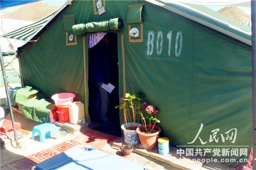 安置區內一戶人家的帳篷外種植著花草（李源 攝）